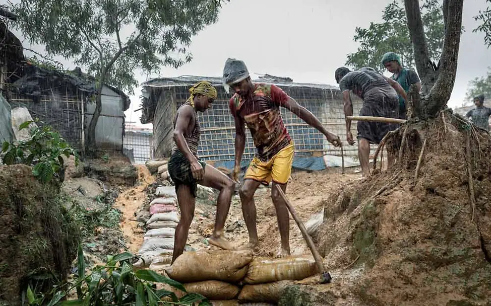 Monsun in Bangladesch: Zwei Männern sichern einen Weg mit Sandsäcken | © UNICEF/Brown Monsun in Bangladesch 2019: Zwei Männer sichern einen Weg mit Sandsäcken