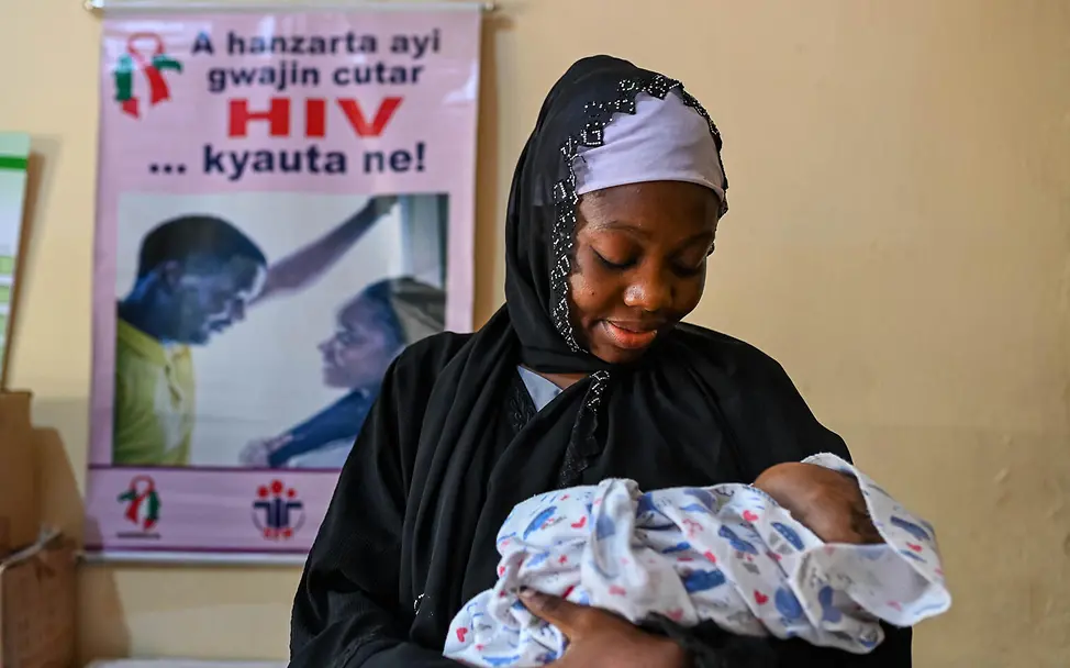 Eine junge Mutter mit ihrem Baby | © UNICEF/UNI610460/Adesegun EIne junge Mutter hält ihr Neugeborenes im Arm