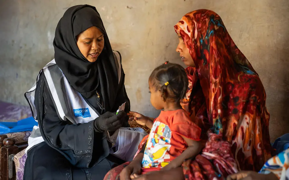 Tawsal berät Mütter zu gesunder Ernährung. | © UNICEF/UNI962620/Elfati Sudan Hungersnot: UNICEF-Mitarbeiterin gibt Mutter Spezialnahrung