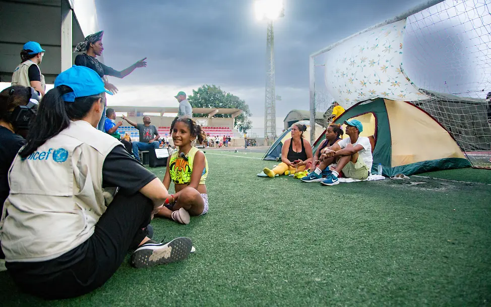 Eine UNICEF-Helferin unterhält sich in einer Notunterkunft mit einem Mädchen | © UNICEF/Párraga Venezuela Erdbeben spenden: Eine UNICEF-Helferin unterhält sich in einer Notunterkunft mit einem Mädchen